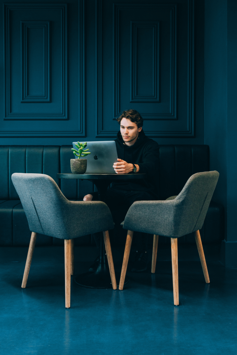 Man sitting in front of his laptop when practicing hybrid work (working from home).