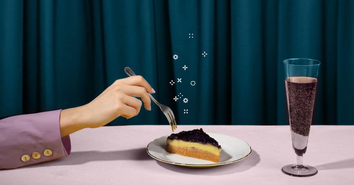 Hand holding a fork reaching for a piece of tart on a pink table with a glass of champagne on right – blog discussing why there's no need to edit pdfs