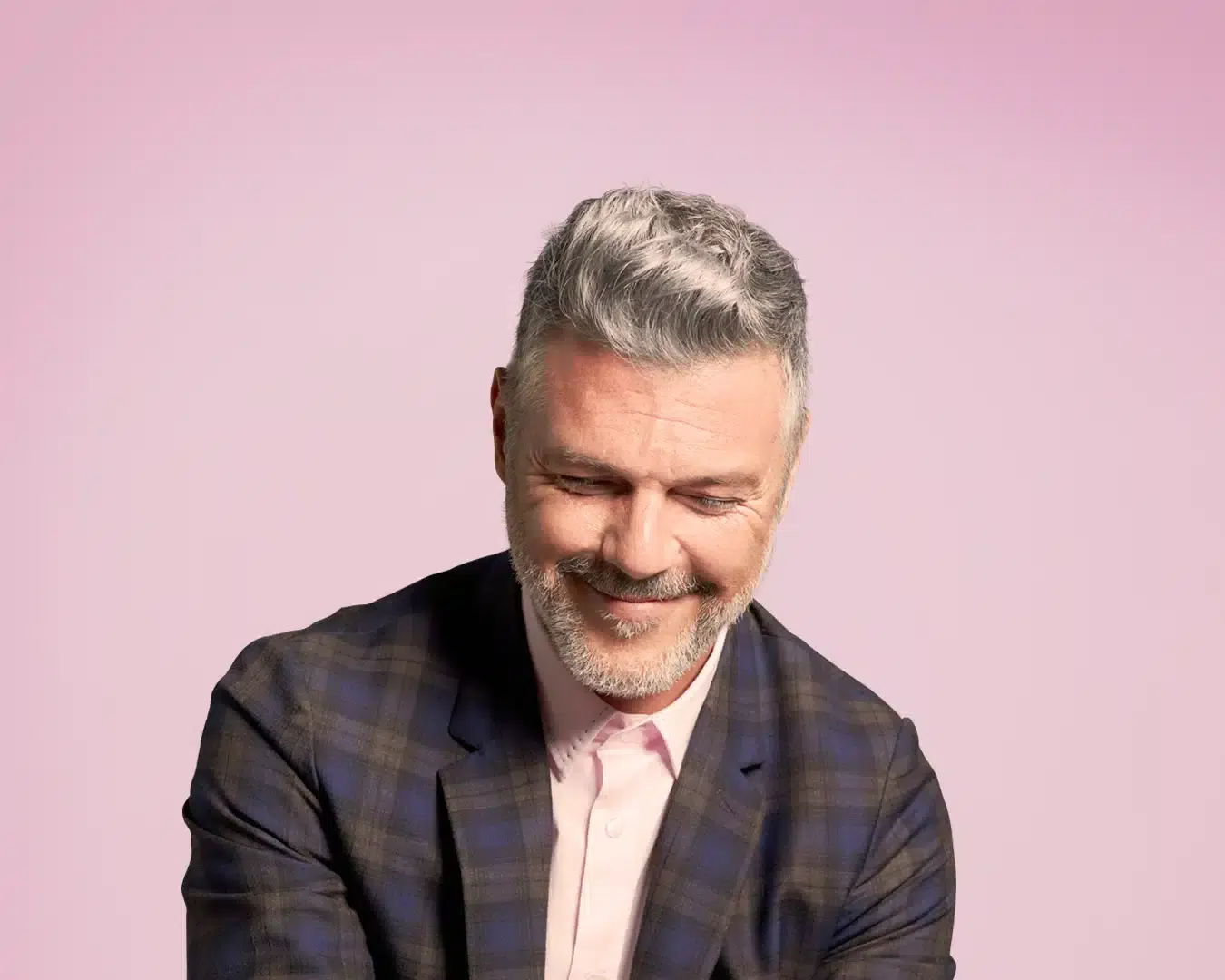 An older man in a suit smiling at the ease of using HubSpot eSignature tools integrations