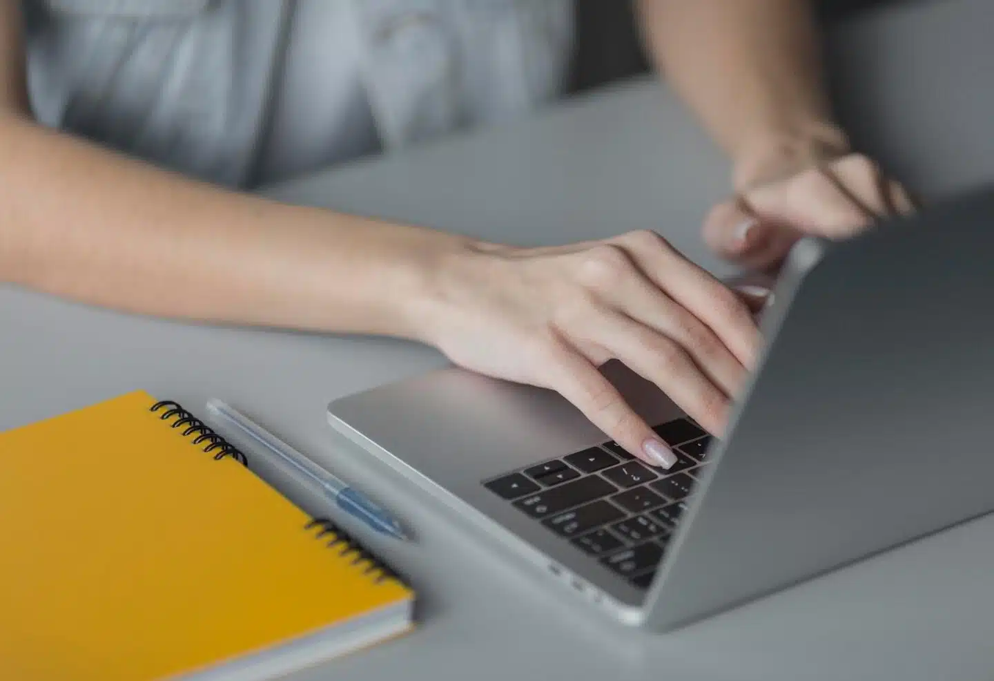 A close of up of a person drafting responses for proposals on their laptop